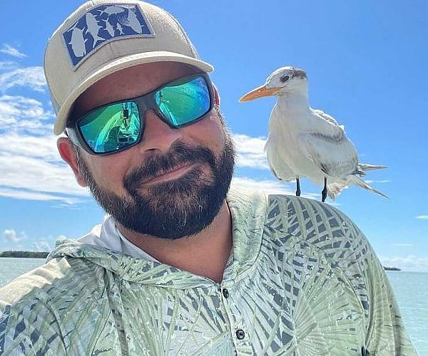  Man poses with bird on shoulder