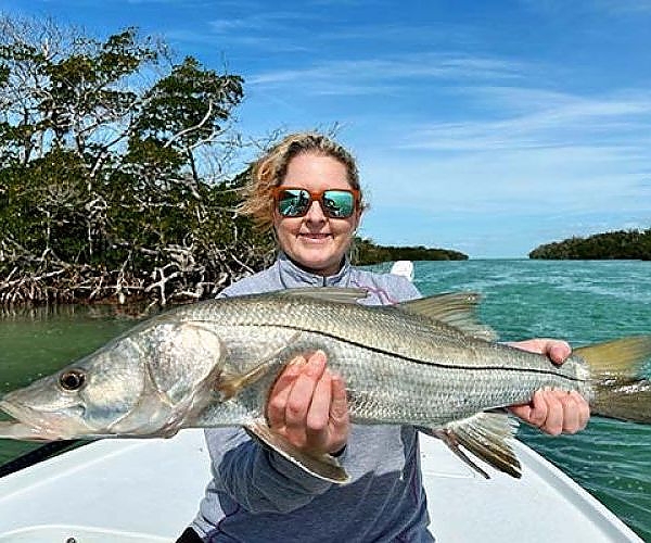 Woman holding up her catch